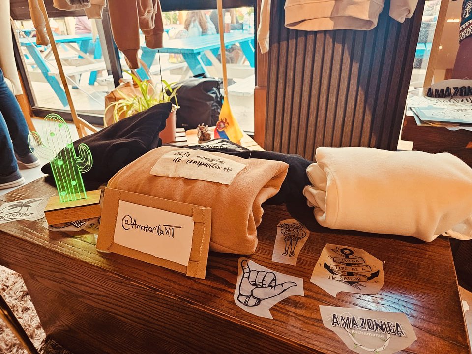 Folded custom hoodies and printed pieces presented on a wooden table